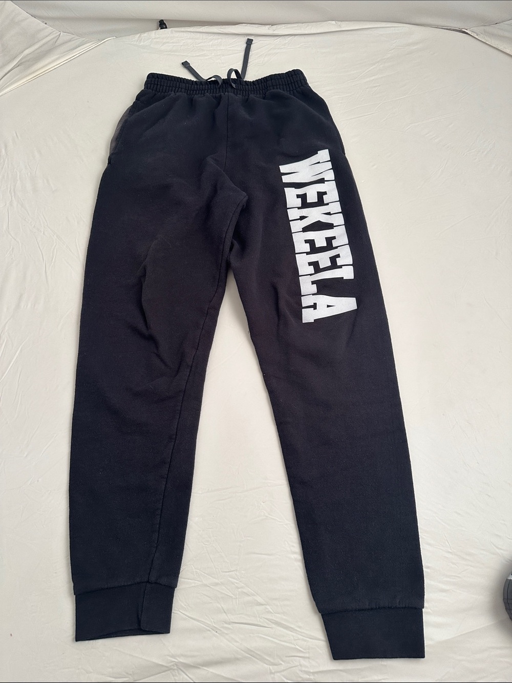 Jerzees black drawstring side pocket joggers with white Wekeela logo down leg  S